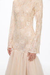 Long sleeved dress in vanilla with asymmetrical skirt